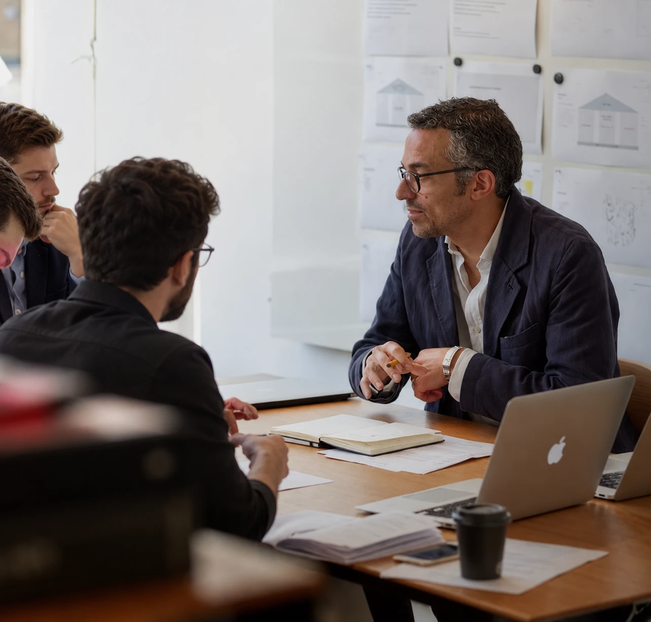 An Apex Global Solutions leader in a review meeting with a client