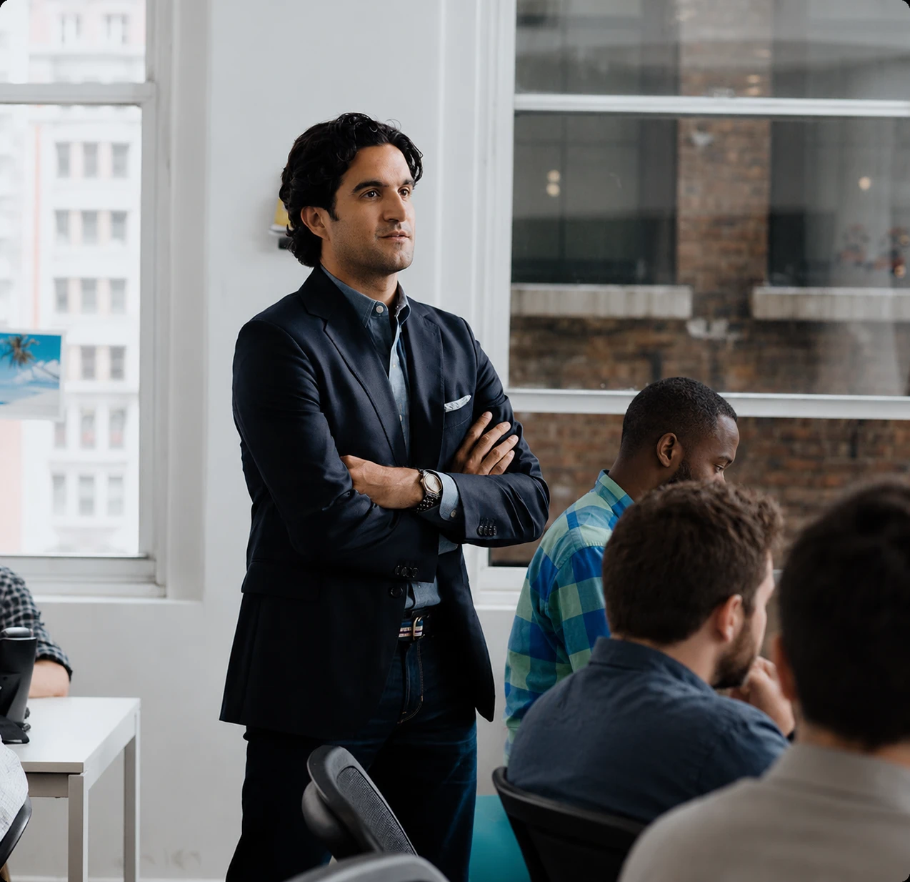 Apex Global Solutions team member leading a meeting with colleagues