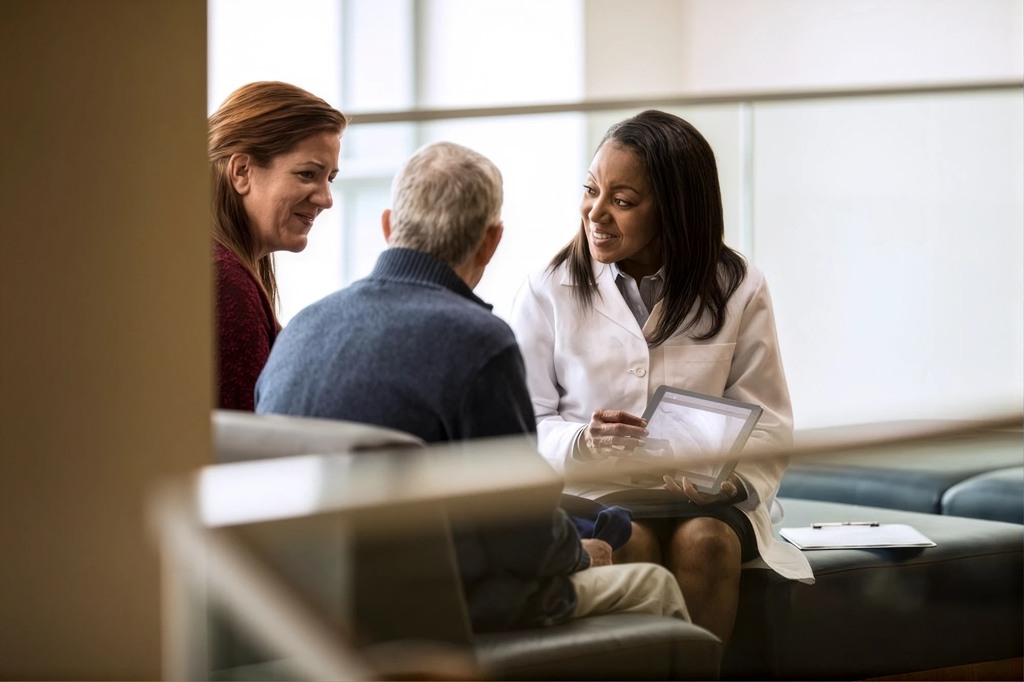 A clinician talking with a resident and family member